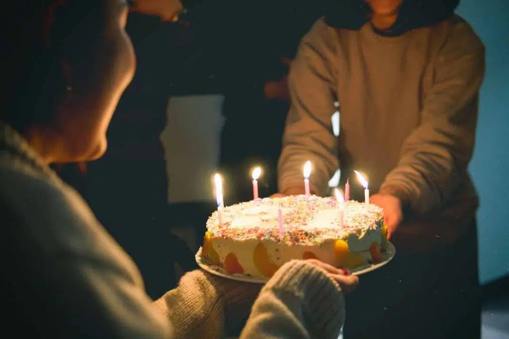 Two People Holding birthday Cake With Lit Candles - Free birthday cake images