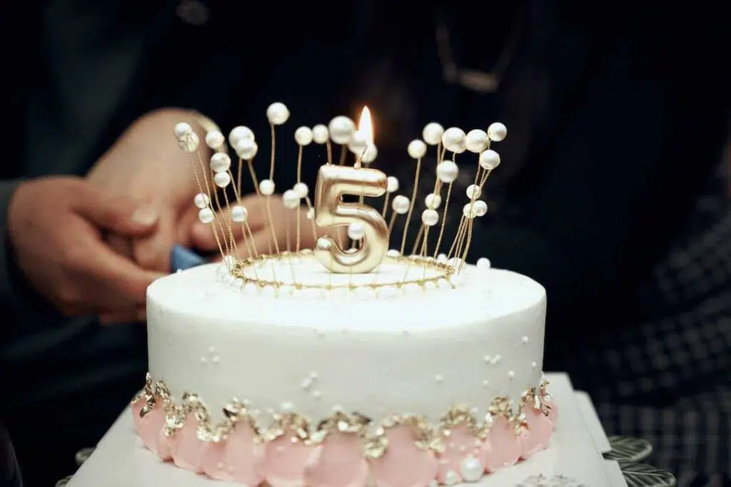 White and Gold birthday Cake With a Lighted Candle - Free birthday cake images