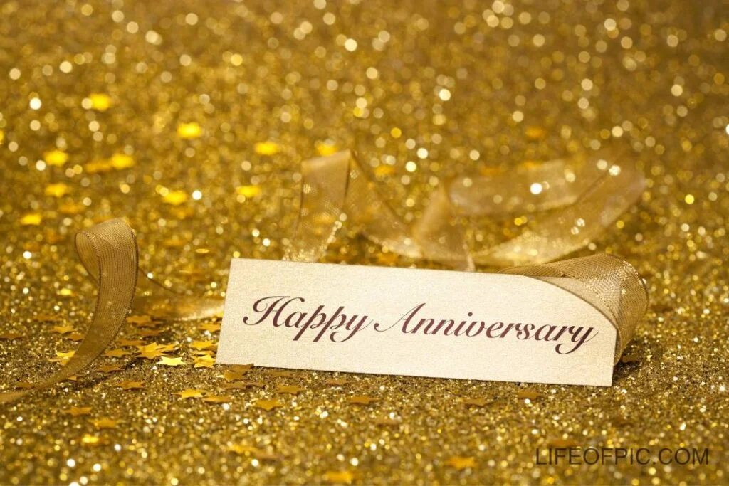 Happy anniversary place card shot against defocussed glittery background - happy anniversary images