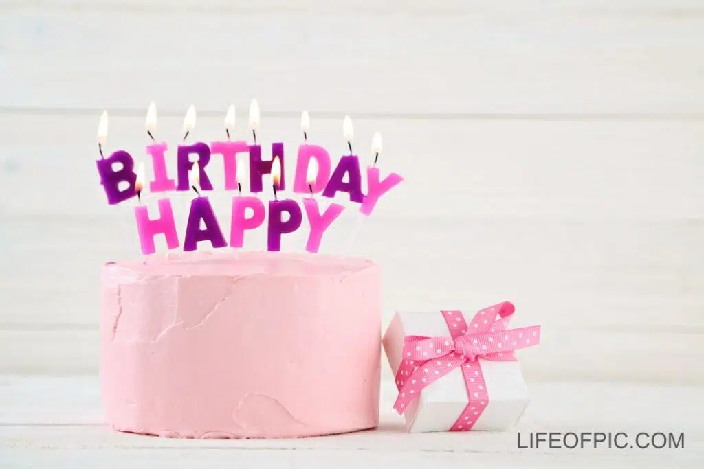 Pink happy birthday cake with candles - Free birthday cake images