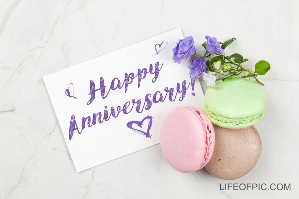Writing a Happy Anniversary postcard on white marble table - happy anniversary images