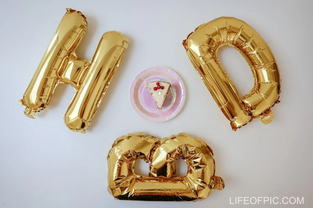 Slice Of Cake Beside Gold Balloons - Free birthday cake images