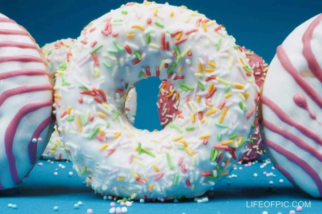 Close Up Photo of Colorful Donuts on a Blue Surface - Donuts Images