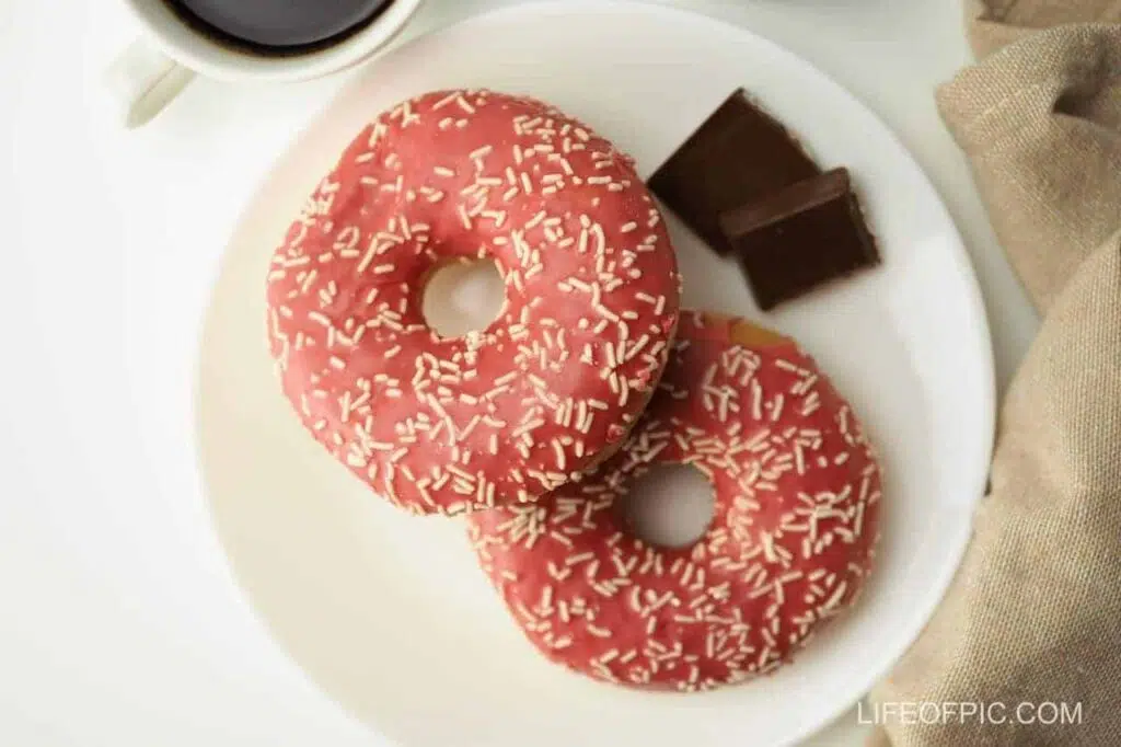 Two Pink Doughnuts on Plate - Donuts Images