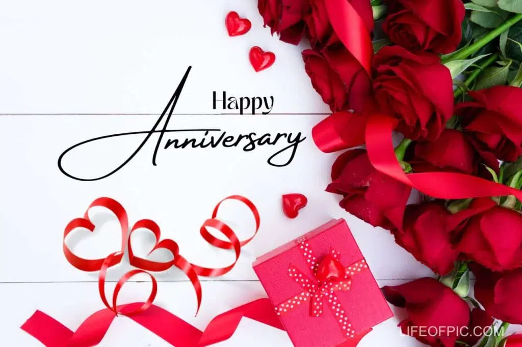 A bouquet of roses and a gift box - happy anniversary images